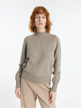 a lady in a cashmere mock neck pullover sweater